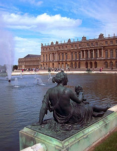 Palace of Versailles with fountain and statue in foreground
